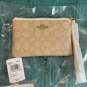 Tan coach wristlet.